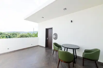 a dining room with a table and green chairs at Hotel Mysore Radiance in Mysore
