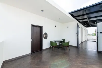 a dining room with a table and green chairs at Hotel Mysore Radiance in Mysore
