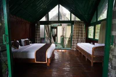 a bedroom with two beds in a room with windows at Gorukana Eco Wellness Centre in Honganūr