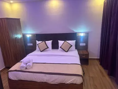 a bedroom with a large bed with two slippers on it at Golden hills cottage in Viripara