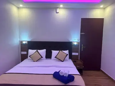 a bedroom with a bed with two hats and pillows at Golden Hills cottage munnar Mankulam Munnar in Viripara