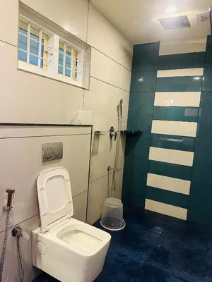 a bathroom with a toilet and a shower at Golden Hills cottage munnar Mankulam Munnar in Viripara