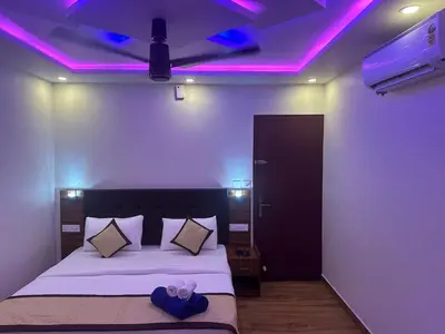 a bedroom with a bed with purple lights on the ceiling at Golden Hills cottage munnar Mankulam Munnar in Viripara
