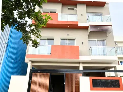 a building with orange and blue paint on it at Mannat Inn Classic Premium - 3BHK in Mysore