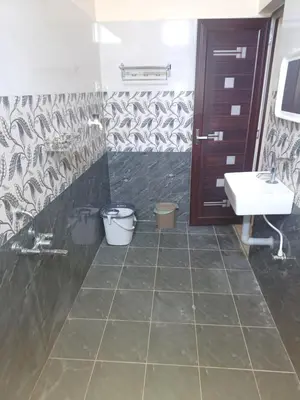 a bathroom with a sink and a toilet and a shower at Sapna residency in Mettuppālaiyam