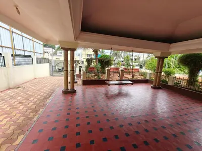 an empty lobby with a red and blue tile floor at Emerald Luxury Villa in Mysore