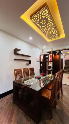 a dining room with a glass table and chairs at Le Casabella in Kalpetta