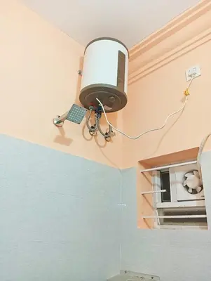 a lamp hanging from the ceiling of a bathroom at KPR Residency Near Isha - Adiyogi in Alāndurai