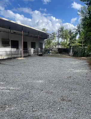an empty parking lot in front of a building at Scott legacy apartment in Kulattūr