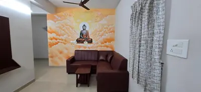 a living room with a couch and a painting at PPH Living Arvind Inn in Coimbatore