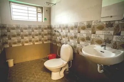 a bathroom with a toilet and a sink at Green Nest Villa at Athirappilly in Athirappilly