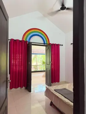 an open door with a rainbow in a room at Dream House Near IIM Kozhikode & NIT Calicut in Kozhikode