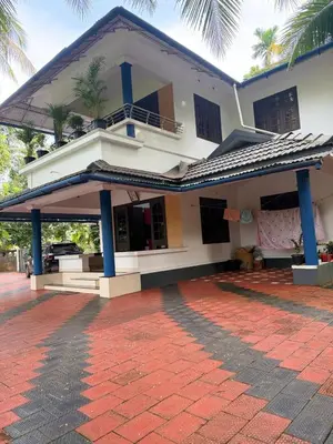a house with a red brick driveway in front of it at Dream House Near IIM Kozhikode & NIT Calicut in Kozhikode