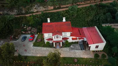 an aerial view of a large house with a red roof at The Humming Bird A Stay Chapter in Ooty