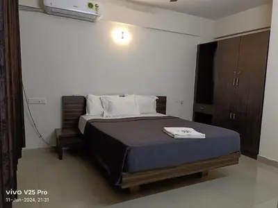 a bedroom with a bed in a room at VVP service Apartments in Nedumbassery