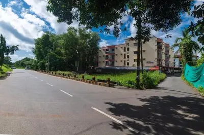 an empty street with a building on the side of the road at VVP service Apartments in Nedumbassery