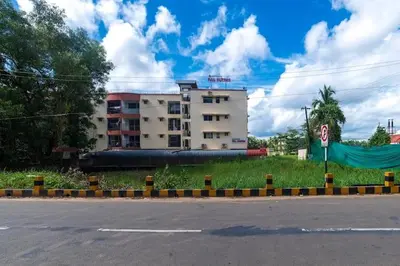 an empty street with a building in the background at VVP service Apartments in Nedumbassery