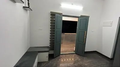 an empty room with a green door and a window at Dutch Heaven - Luxury Rental Villa Near Cochin Airport in Nedumbassery