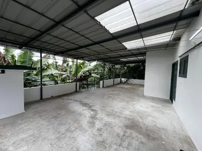 a large empty room with a lot of plants at Dutch Heaven - Luxury Rental Villa Near Cochin Airport in Nedumbassery
