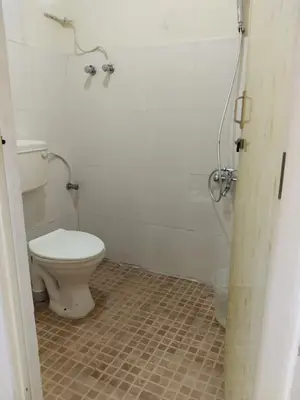 a bathroom with a toilet and a shower at GEM Stays in Ooty