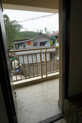an open door to a balcony with a house at Signature by Rayhan in Vālpārai