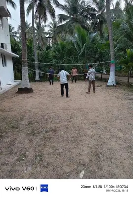 a group of people playing a game of volleyball at Limra Farm House in Pollāchi