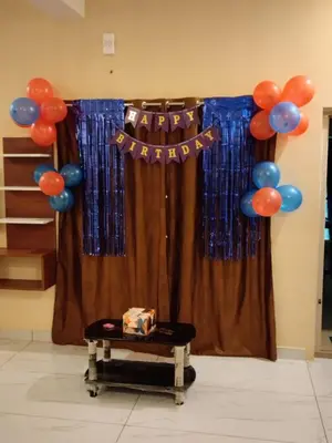 a curtain with a happy birthday sign and balloons at Limra Farm House in Pollāchi