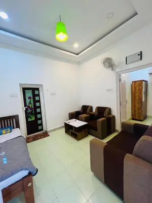 a living room with a couch and a table at 7FORT HOMESTAY Athirappilly in Athirappilly