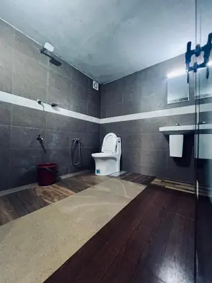 a bathroom with a toilet and a sink at 7FORT HOMESTAY Athirappilly in Athirappilly