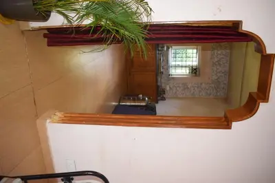 a bathroom with a mirror and a sink at Mass villa in Ooty