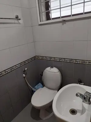 a bathroom with a toilet and a sink at Trilan Cottages - Donnington Road in Kotagiri