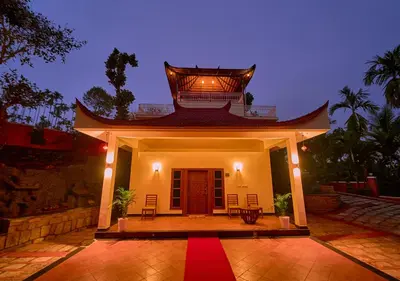 a house with a red carpet in front of it at Ushasree Wayanad Premium Pool Resort by VOYE HOMES in Ambalavayal
