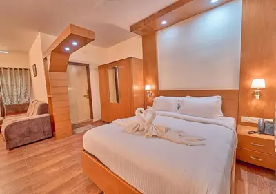 a bedroom with a large bed with a ribbon on it at Ushasree Wayanad Premium Pool Resort by VOYE HOMES in Ambalavayal