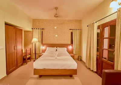 a bedroom with a large bed in a room at Ushasree Wayanad Premium Pool Resort by VOYE HOMES in Ambalavayal
