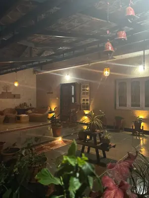 a living room with a lot of plants and lights at Coorg Naladi holidays in Kakkabe