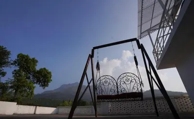 a balcony with a view of the sky and mountains at PADIKKAL BUNGLOW in Vayittiri