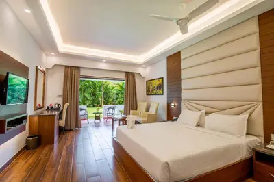 a hotel room with a bed and a television at Avana Resort in Mettuppālaiyam