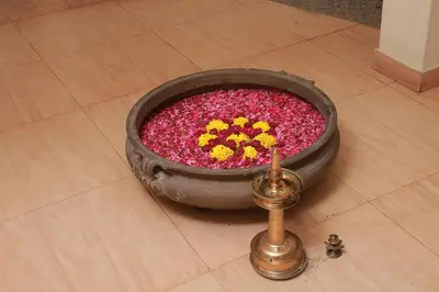 a large pot filled with pink and yellow flowers at Wariyam Heritage in Trichūr