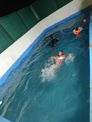 a group of people swimming in a swimming pool at Lilly Farm in Halgūr