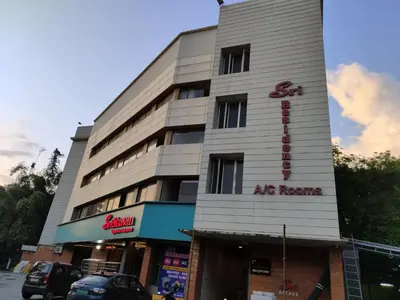 a building with a sign on the side of it at Sri bhavan residency in Palakkad