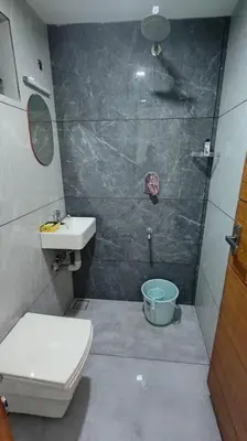 a bathroom with a shower and a toilet and a sink at Krishnarpanam 2BHK villa in Guruvayoor- only for families in Guruvāyūr