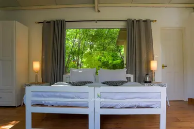 a white bed in a room with a window at 42 Green Pastures By Lexstays -Tea Estate Experience in Coonoor