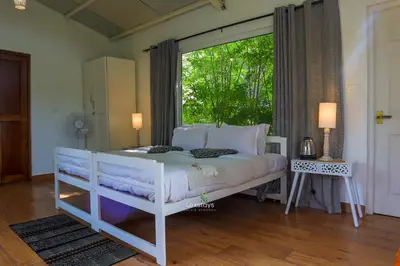 a white bed in a room with a window at 42 Green Pastures By Lexstays -Tea Estate Experience in Coonoor