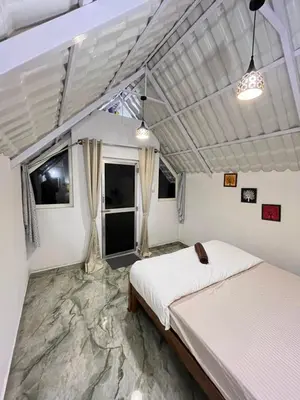 a bedroom with a large bed in a room at TauSco Homestay & Campsite - Coorg in Madikeri