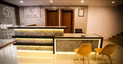 a fish tank in a room with two chairs at hotel emperor in Sultan Bathery