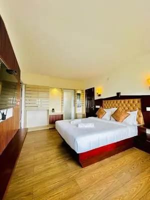 a large bedroom with a large bed in it at Kanavu Valley View in Ooty