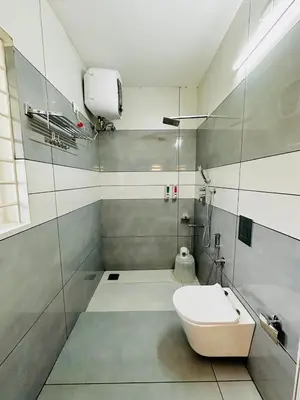 a bathroom with a sink and a toilet in it at Kanavu Valley View in Ooty