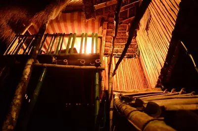 a room with rows of chairs in a building at Greenways Tree House and Mud House in Chekadi