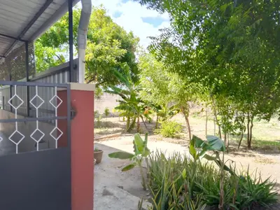 a gate to a house with trees in the background at SHIs Aathira 2bhk Heart of Coimbatore in Coimbatore