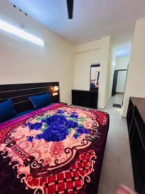 a bedroom with a large bed with a colorful bedspread at G Mount inn in Munnar